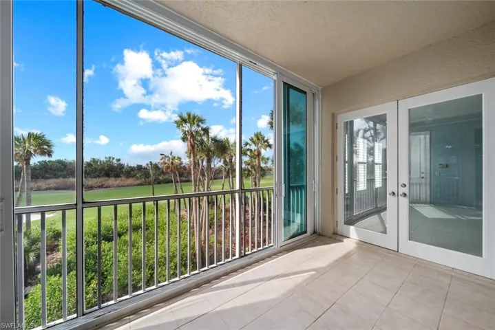 Unfurnished sunroom featuring a wealth of natural light and french doors