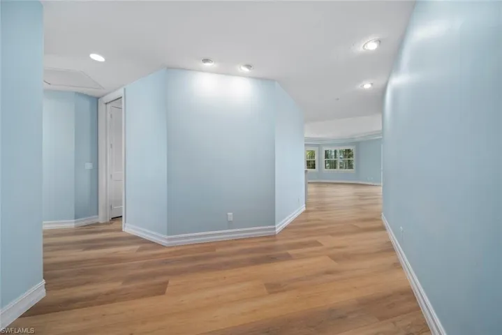 Corridor with light wood-type flooring