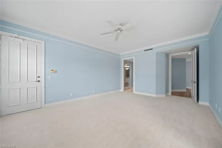 Carpeted spare room with ornamental molding and ceiling fan