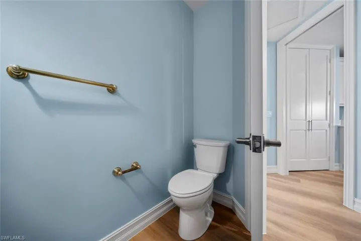 Bathroom featuring toilet and wood-type flooring