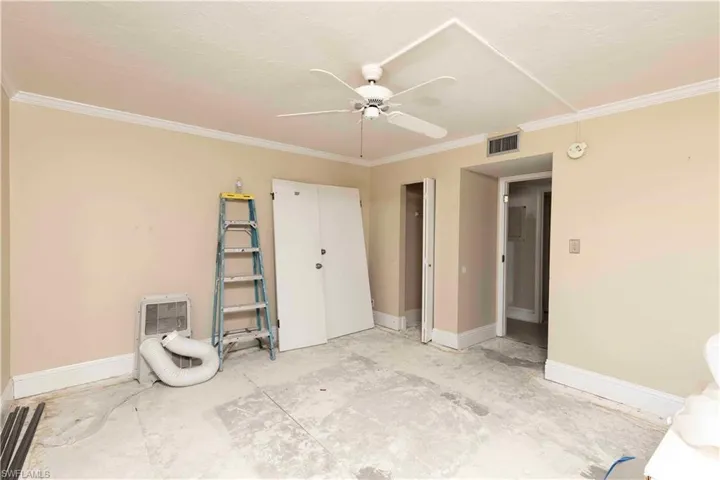 Unfurnished bedroom featuring crown molding and ceiling fan