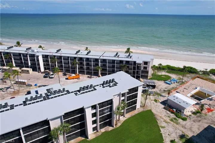 Aerial view featuring a view of the beach and a water view