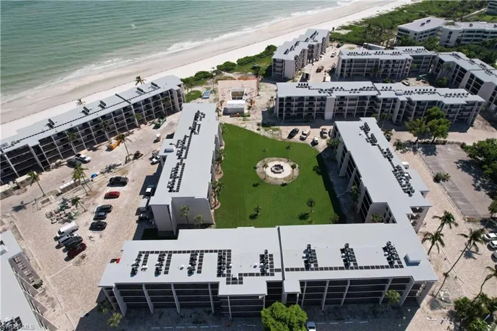 Aerial view featuring a water view and a view of the beach