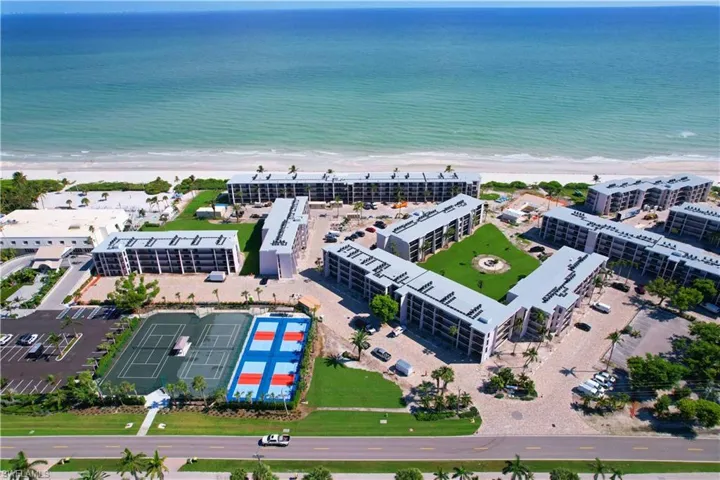 Drone / aerial view featuring a water view and a view of the beach
