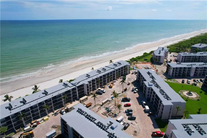 Drone / aerial view with a beach view and a water view