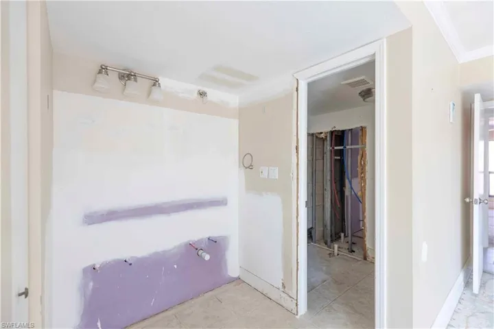 Bathroom featuring crown molding and tile patterned flooring