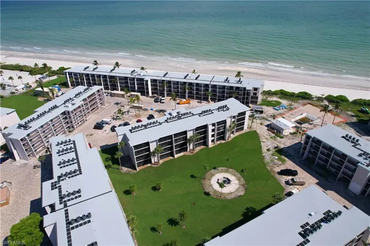 Birds eye view of property featuring a view of the beach and a water view
