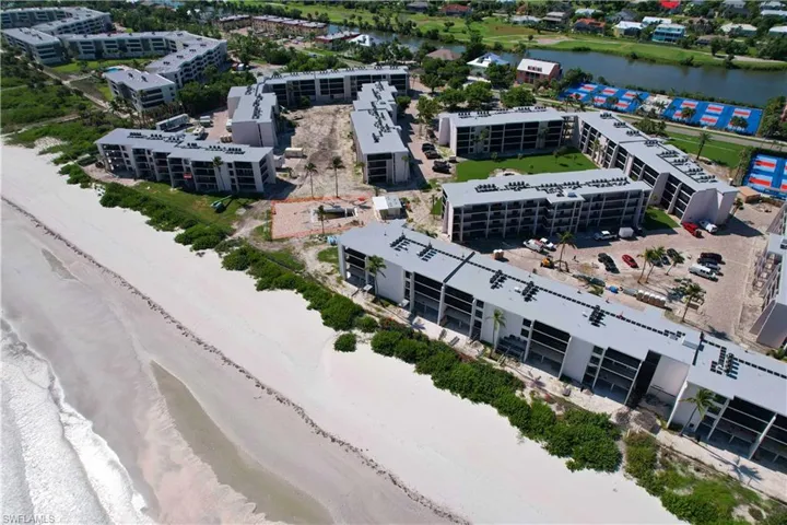Drone / aerial view with a view of the beach and a water view