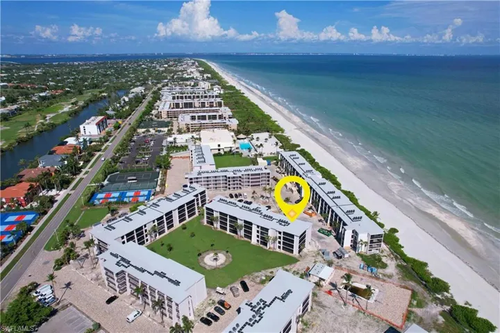 Drone / aerial view with a view of the beach and a water view