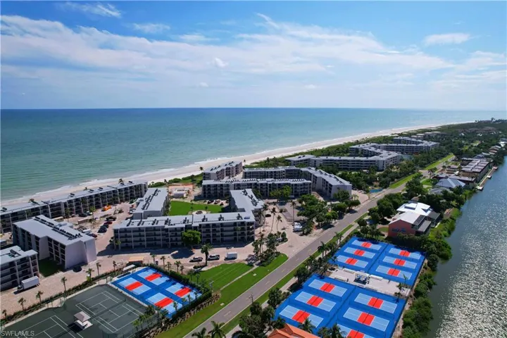 Birds eye view of property featuring a view of the beach and a water view