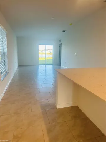 Unfurnished room with light tile patterned floors