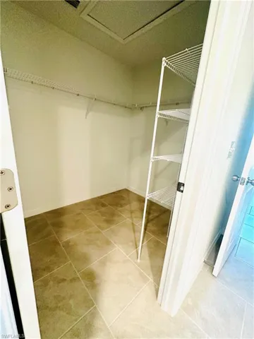 Walk in closet featuring light tile patterned flooring