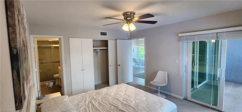 Bedroom with ceiling fan, a closet, and ensuite bathroom