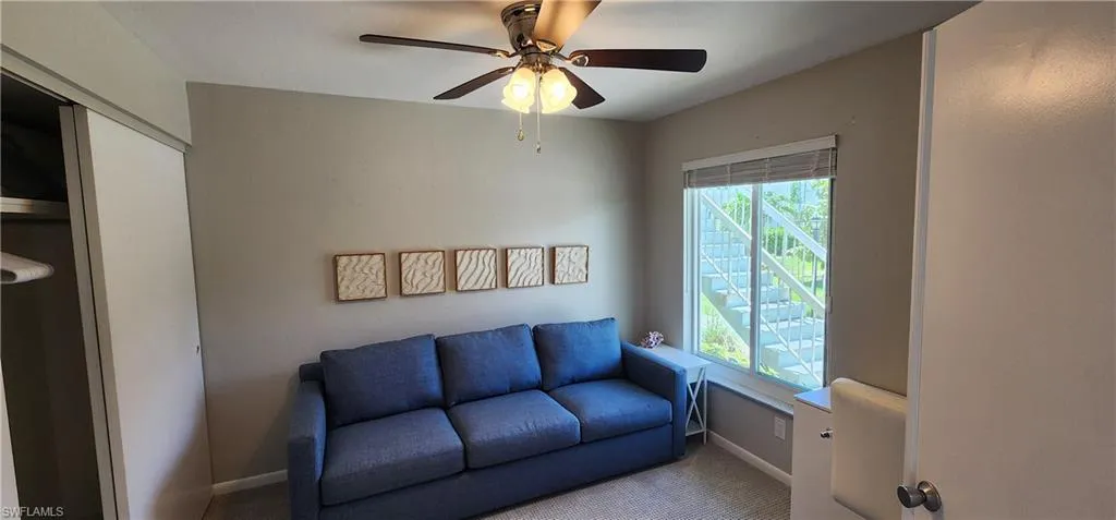 Sitting room featuring a wealth of natural light, carpet floors, and ceiling fan