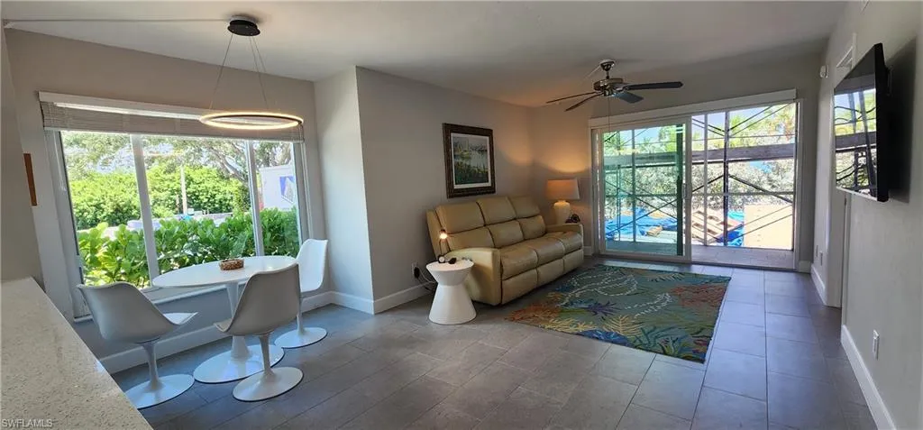 Sitting room with plenty of natural light and ceiling fan