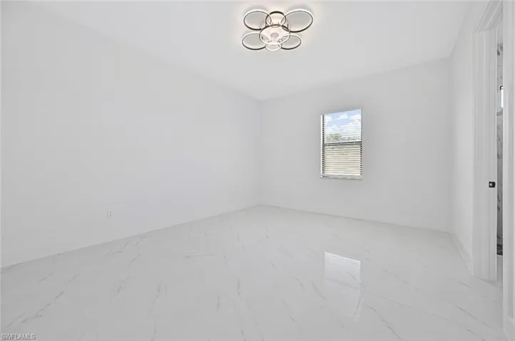 Empty room with light marble finish flooring and baseboards