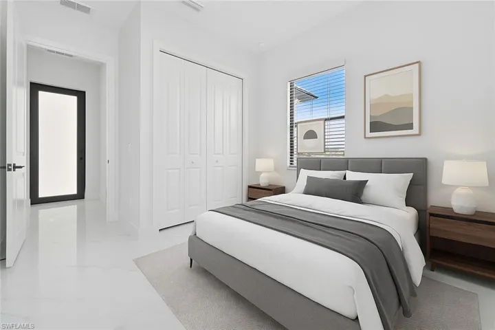 Bedroom with a closet and light marble finish flooring