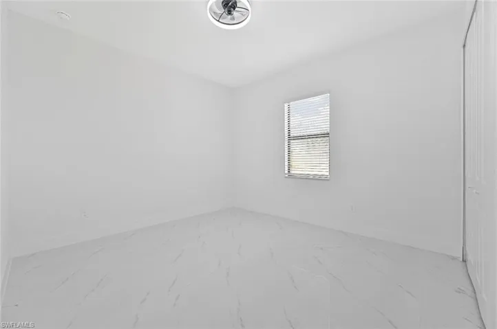 Empty room with light marble finish floors and baseboards