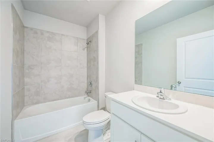 Bathroom featuring washtub / shower combination and vanity