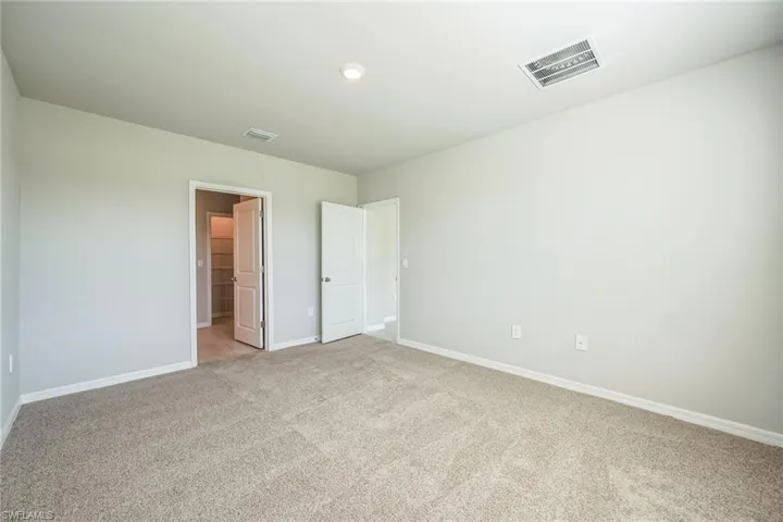 Unfurnished bedroom with baseboards and carpet floors