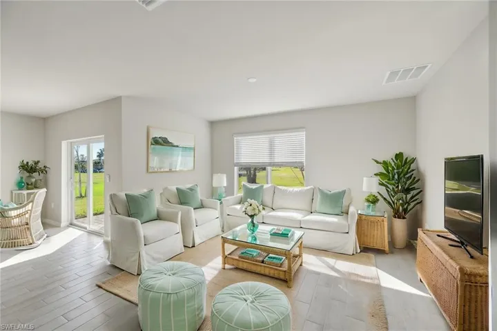 Living room featuring wood finished floors and healthy amount of natural light