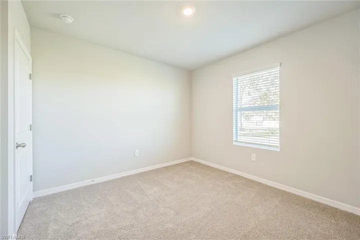 Unfurnished room featuring baseboards and carpet