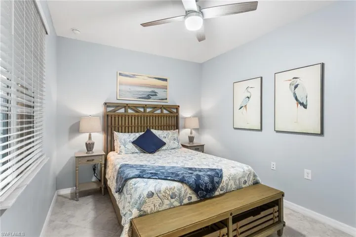 Bedroom with ceiling fan and baseboards