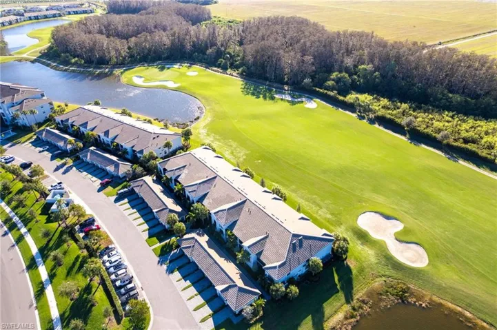 Aerial overview of property's location with a nearby body of water and a local golf course
