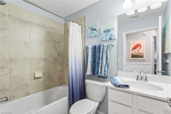 Bathroom featuring shower / bath combo and vanity