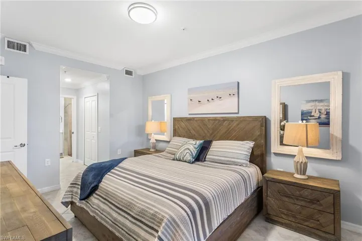 Bedroom with crown molding and a closet