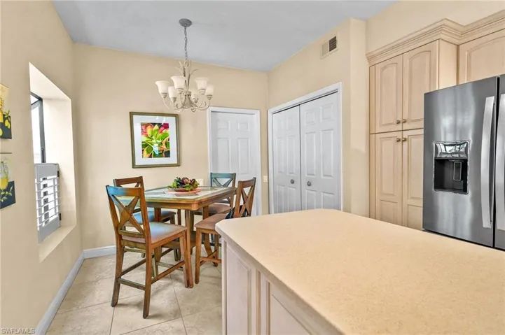 Dining area featuring a chandelier and light tile patterned flooring