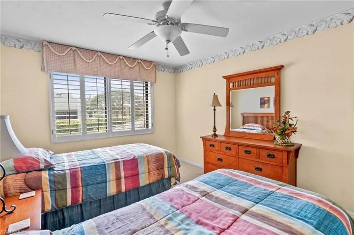 Bedroom with a ceiling fan and carpet floors
