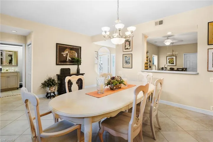 Dining room featuring light tile patterned floors, a chandelier, ceiling fan, and recessed lighting