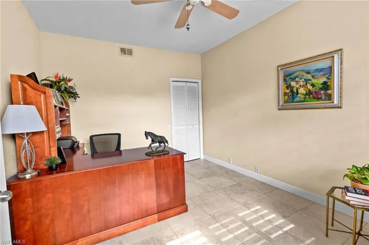 Office featuring light tile patterned floors and ceiling fan