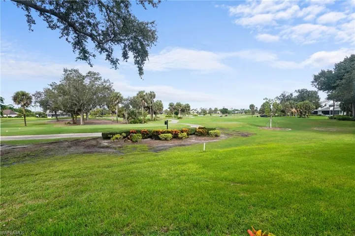 View of community featuring a lawn and view of golf course