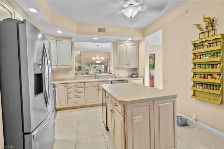 Kitchen with appliances with stainless steel finishes, light countertops, a chandelier, recessed lighting, and light tile patterned flooring