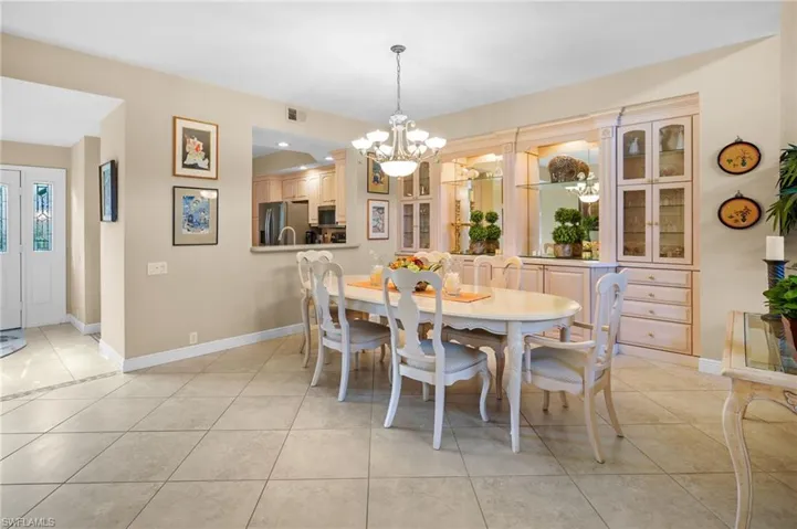 Dining space with a chandelier and light tile patterned flooring