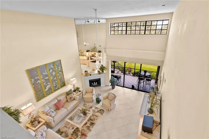 Living area with a towering ceiling, healthy amount of natural light, and tile patterned floors
