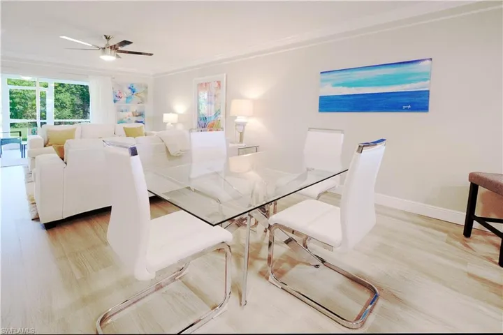 Dining area featuring ceiling fan, ornamental molding, and light hardwood / wood-style floors