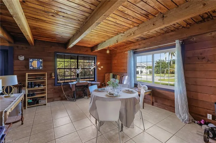 Dining room featuring a wealth of natural light, light tile patterned floors, and wooden ceiling
