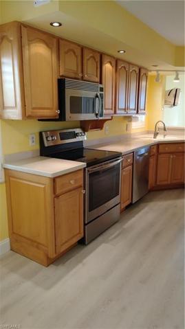 Long View of Kitchen - Stainless Appliances - Corian Counters