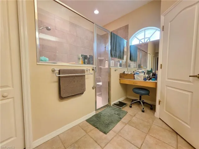 Full bathroom with a shower stall and light tile patterned floors