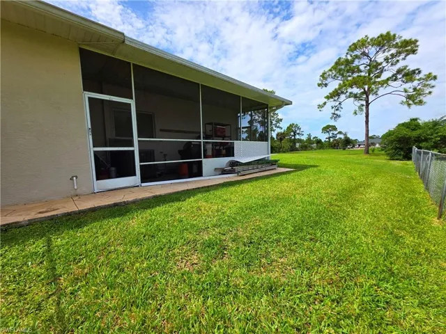 View of yard with a sunroom