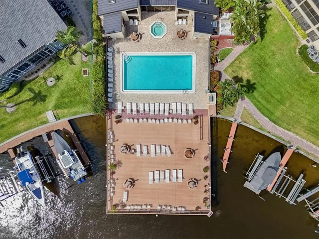 Drone / aerial view of a pool and a large body of water