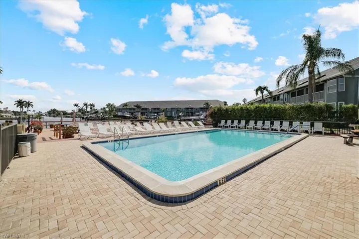 Community pool with a patio