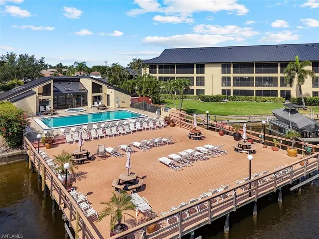Community pool featuring a water view and a patio