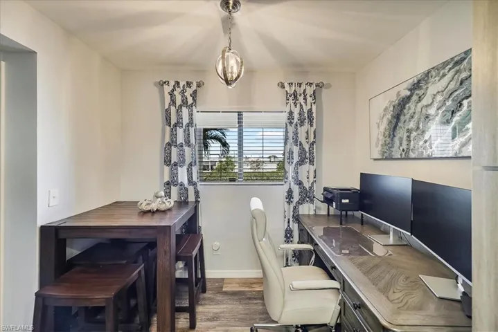 Office area featuring wood finished floors and a chandelier
