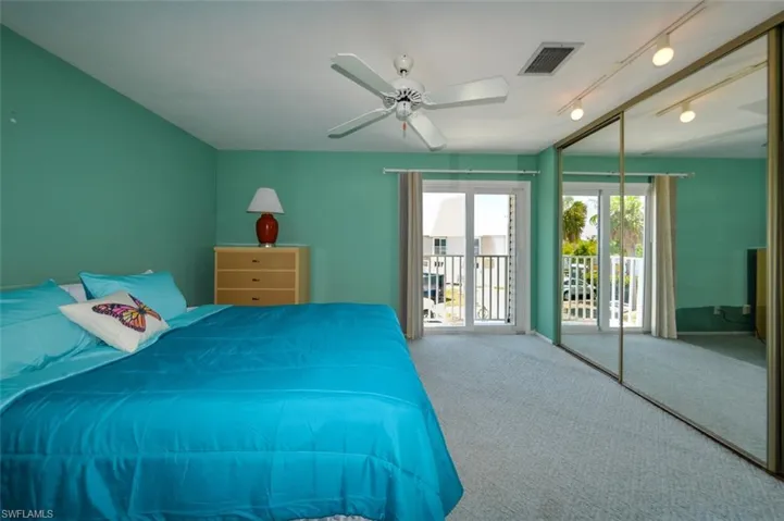 Bedroom with carpet flooring, access to exterior, ceiling fan, and rail lighting