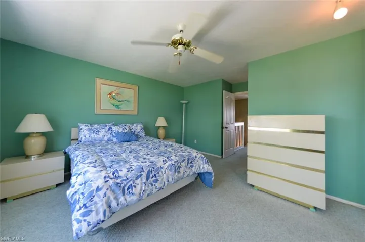 Carpeted bedroom with ceiling fan