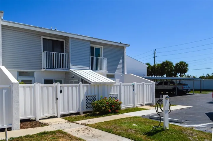 Rear view of townhouse and a balcony